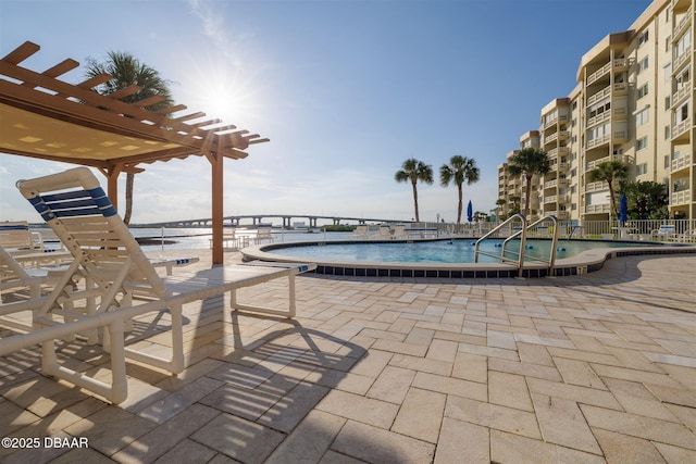 3606 S Peninsula Dr Unit 406, Port Orange, FL 32127 - community pool featuring a pergola, a patio, and a water view