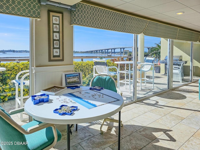 3606 S Peninsula Dr Unit 406, Port Orange, FL 32127 - balcony with a water view, outdoor dining area, and a grill