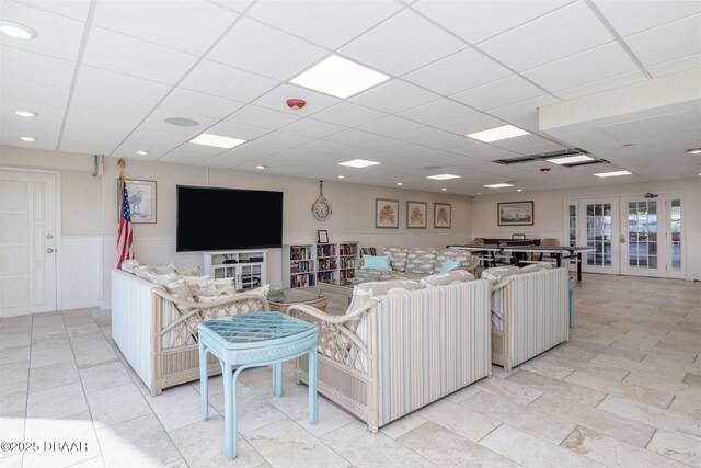 3606 S Peninsula Dr Unit 406, Port Orange, FL 32127 - living room featuring a wainscoted wall, french doors, and a drop ceiling