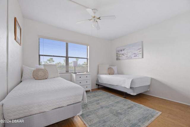 4175 S Atlantic Ave Unit 1130, New Smyrna Beach, FL 32169 - bedroom with wood finished floors, a ceiling fan, and baseboards