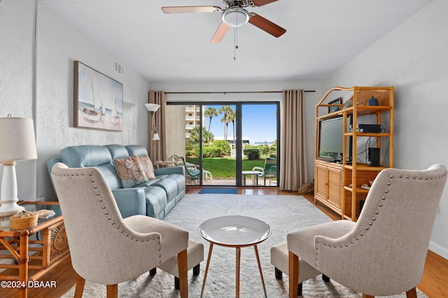 living room with hardwood / wood-style flooring and ceiling fan