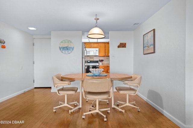 dining area with light wood-type flooring