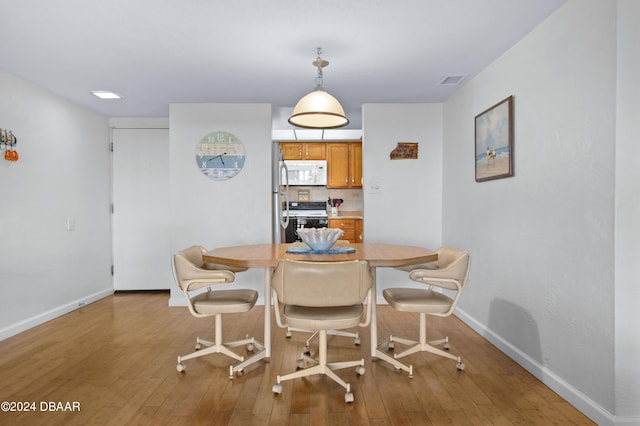 4175 S Atlantic Ave Unit 1130, New Smyrna Beach, FL 32169 - dining area featuring baseboards and wood-type flooring