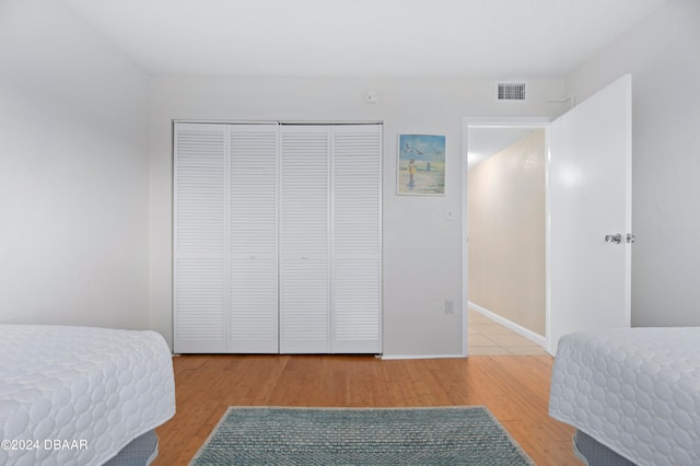 bedroom featuring light hardwood / wood-style floors and a closet