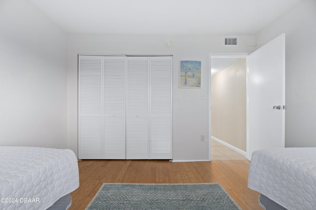 4175 S Atlantic Ave Unit 1130, New Smyrna Beach, FL 32169 - bedroom with wood finished floors, a closet, and baseboards