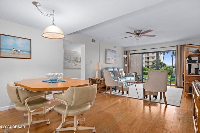 dining area with ceiling fan and light hardwood / wood-style flooring