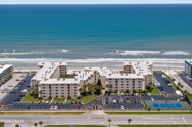 birds eye view of property featuring a beach view and a water view