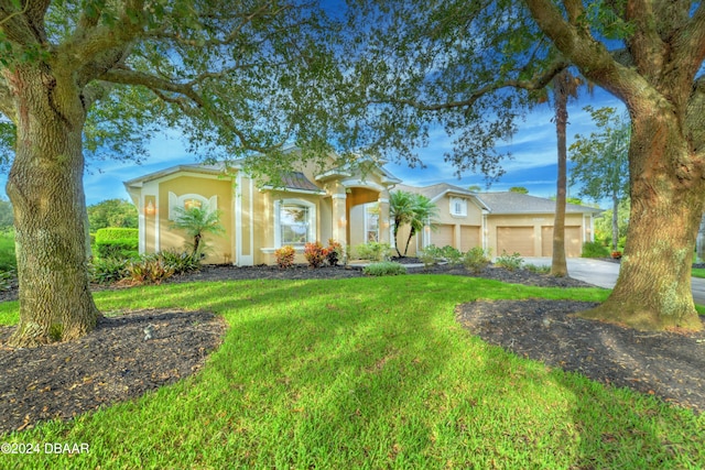 view of front of property with a front lawn and a garage