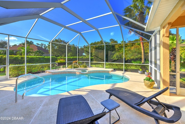 view of pool featuring a patio, glass enclosure, and an in ground hot tub