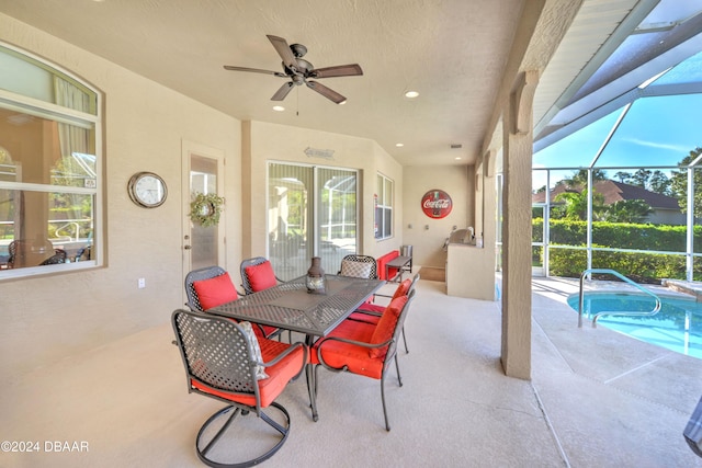 view of patio / terrace featuring glass enclosure and ceiling fan