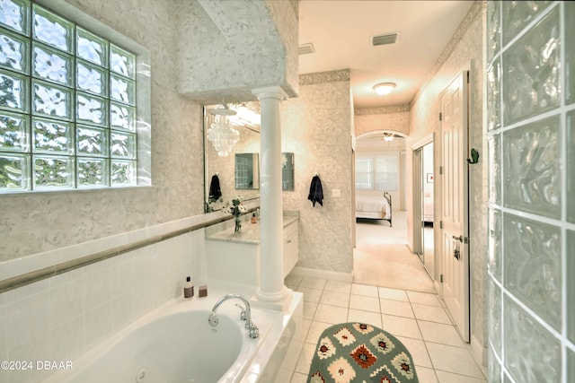 bathroom featuring decorative columns, vanity, tiled bath, and tile patterned floors