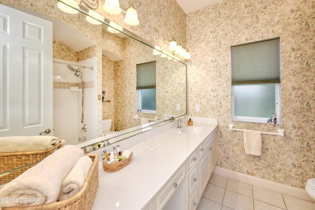 bathroom with tile patterned flooring, vanity, toilet, and a shower with shower door