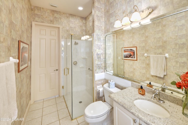 bathroom with a shower with door, tile patterned floors, toilet, and tile walls