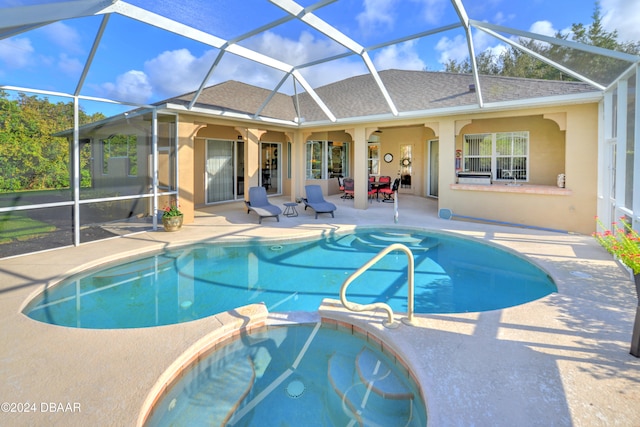 view of pool with a patio and glass enclosure