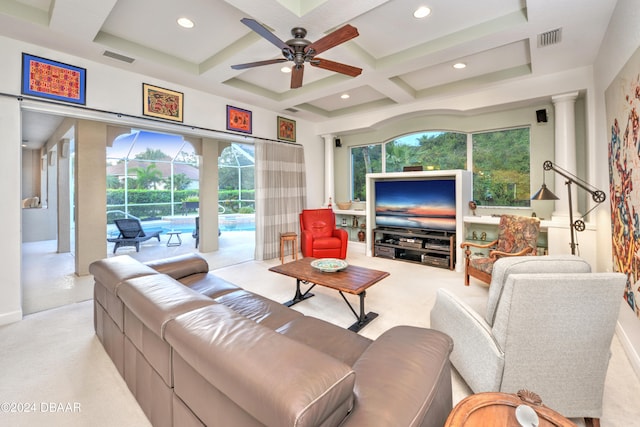 carpeted living room with ceiling fan, beamed ceiling, plenty of natural light, and coffered ceiling