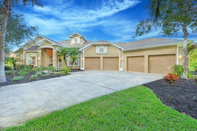 view of front of home featuring a garage and a front yard