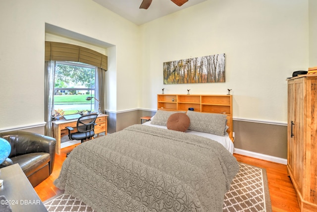 bedroom with hardwood / wood-style floors and ceiling fan