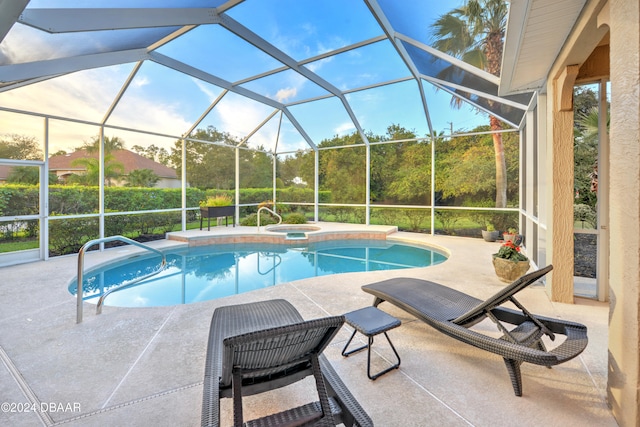 view of swimming pool with a lanai, an in ground hot tub, and a patio area