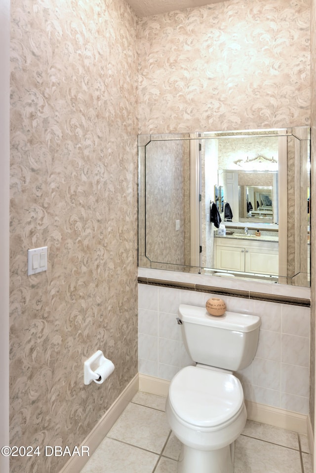 bathroom with toilet and tile patterned flooring