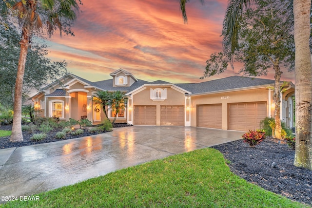 view of front of property featuring a garage and a yard