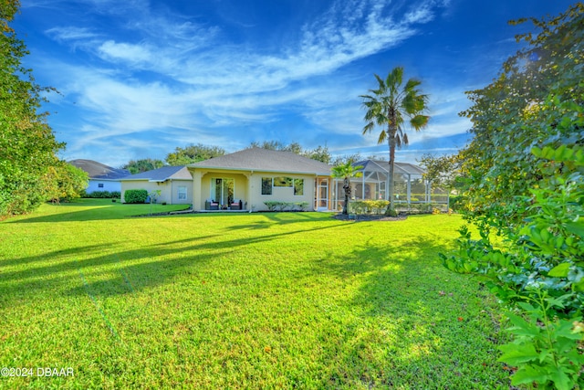 exterior space featuring a lanai and a yard