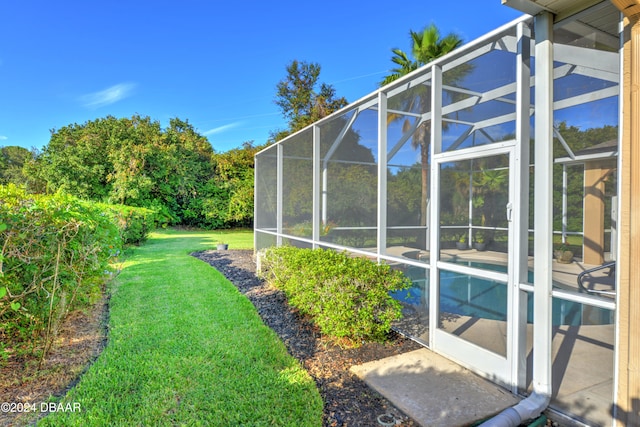 view of yard featuring glass enclosure