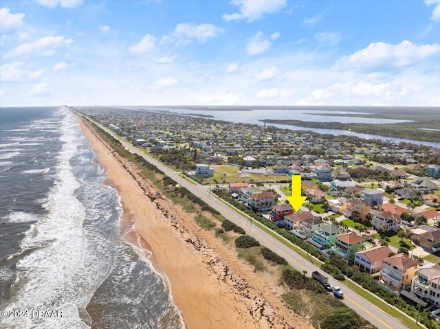 drone / aerial view with a beach view and a water view