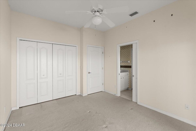 unfurnished bedroom featuring ceiling fan, light colored carpet, and connected bathroom