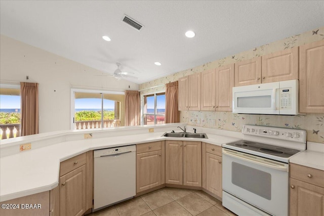 kitchen with a textured ceiling, light brown cabinets, sink, white appliances, and ceiling fan