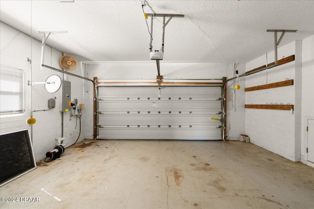 garage with a garage door opener and electric panel