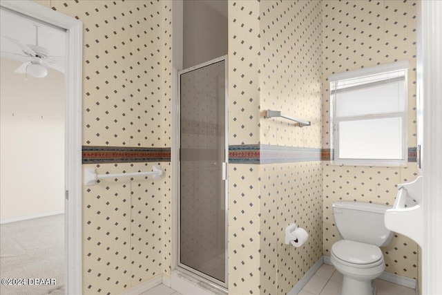 bathroom with walk in shower, toilet, tile patterned floors, and ceiling fan