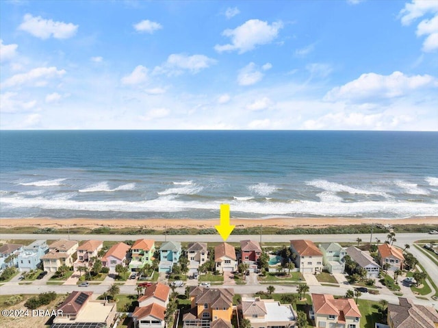 birds eye view of property featuring a beach view and a water view