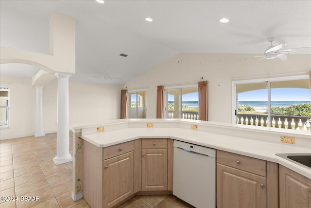 kitchen with dishwasher, decorative columns, lofted ceiling, and light tile patterned floors