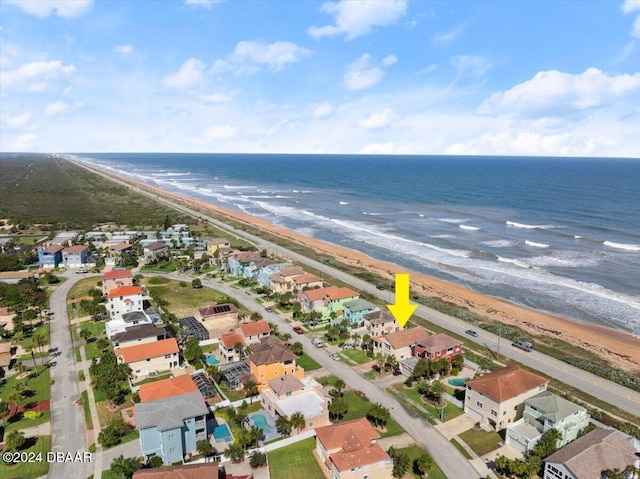 birds eye view of property with a view of the beach and a water view