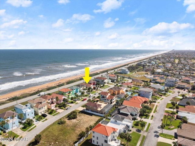 birds eye view of property with a beach view and a water view