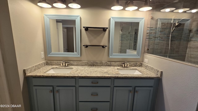 bathroom with tiled shower and vanity