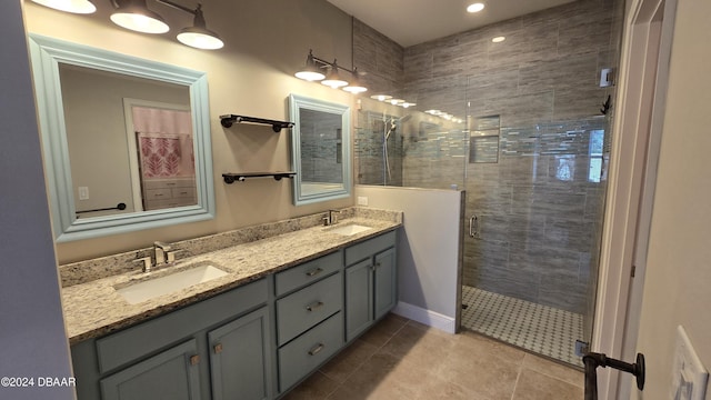 bathroom featuring tile patterned flooring, vanity, and walk in shower