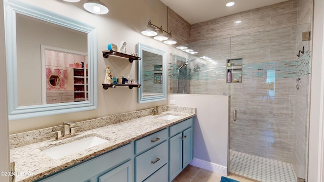 bathroom featuring vanity, tile patterned floors, and walk in shower