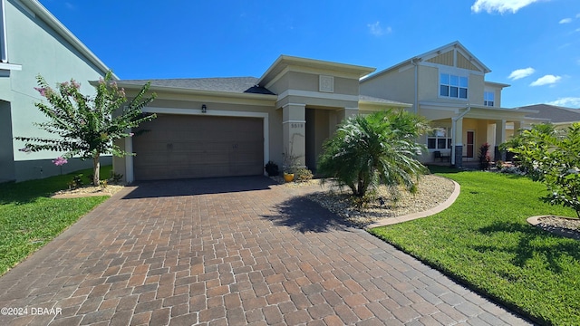 view of front of house with a front yard and a garage