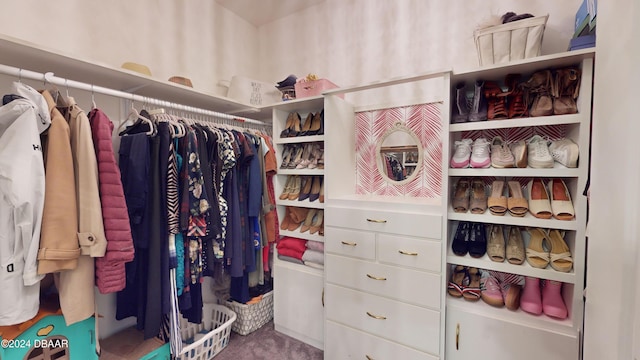 walk in closet featuring carpet flooring