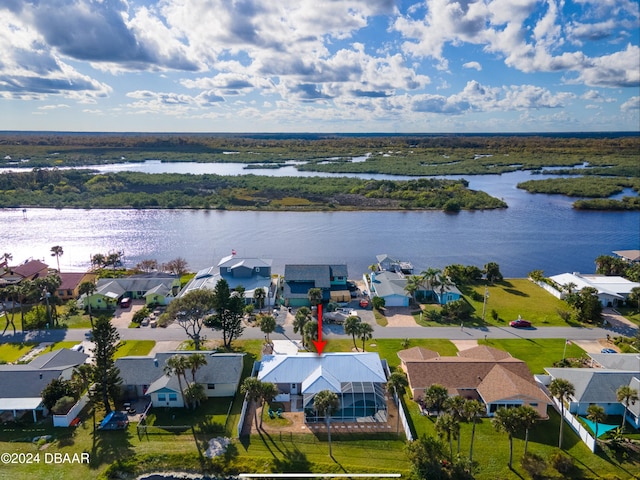 birds eye view of property with a water view