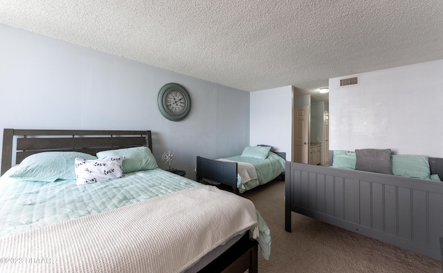 carpeted bedroom featuring a textured ceiling