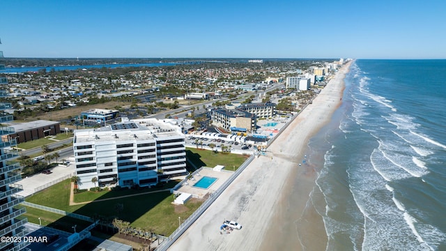 drone / aerial view featuring a beach view and a water view