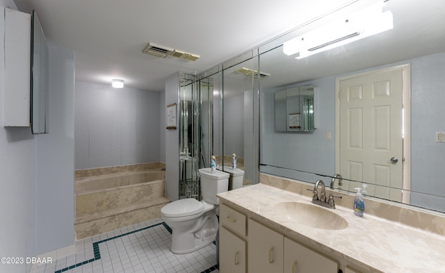 bathroom with vanity, tiled bath, tile patterned floors, and toilet