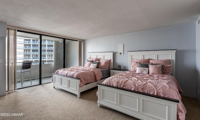 bedroom with light colored carpet and a textured ceiling