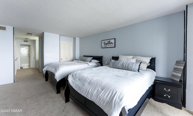 bedroom with light carpet and a textured ceiling