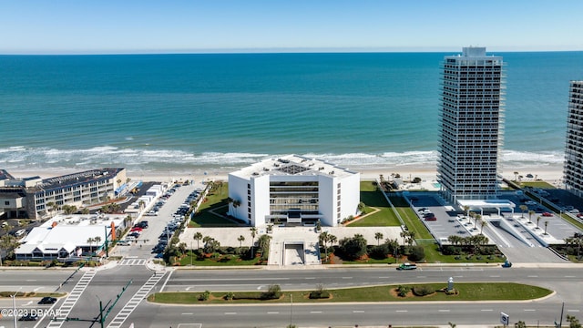 drone / aerial view featuring a beach view and a water view