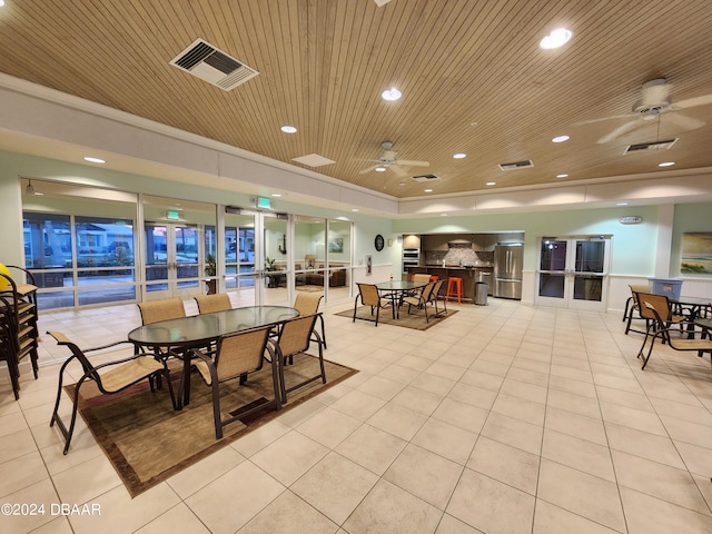 tiled dining area with wood ceiling and ceiling fan