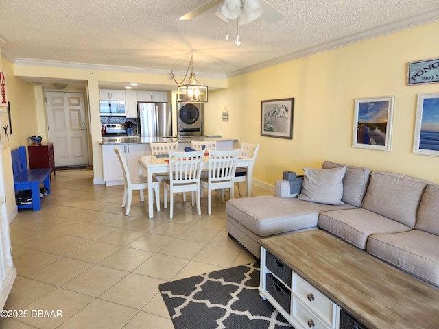 tiled living room with crown molding, stacked washer / drying machine, and a textured ceiling