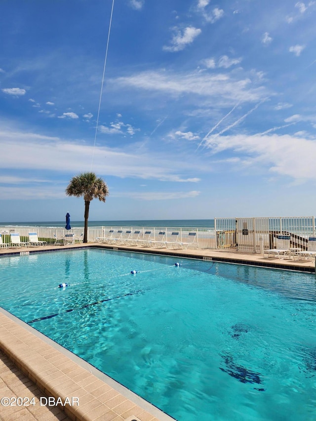 view of pool featuring a water view